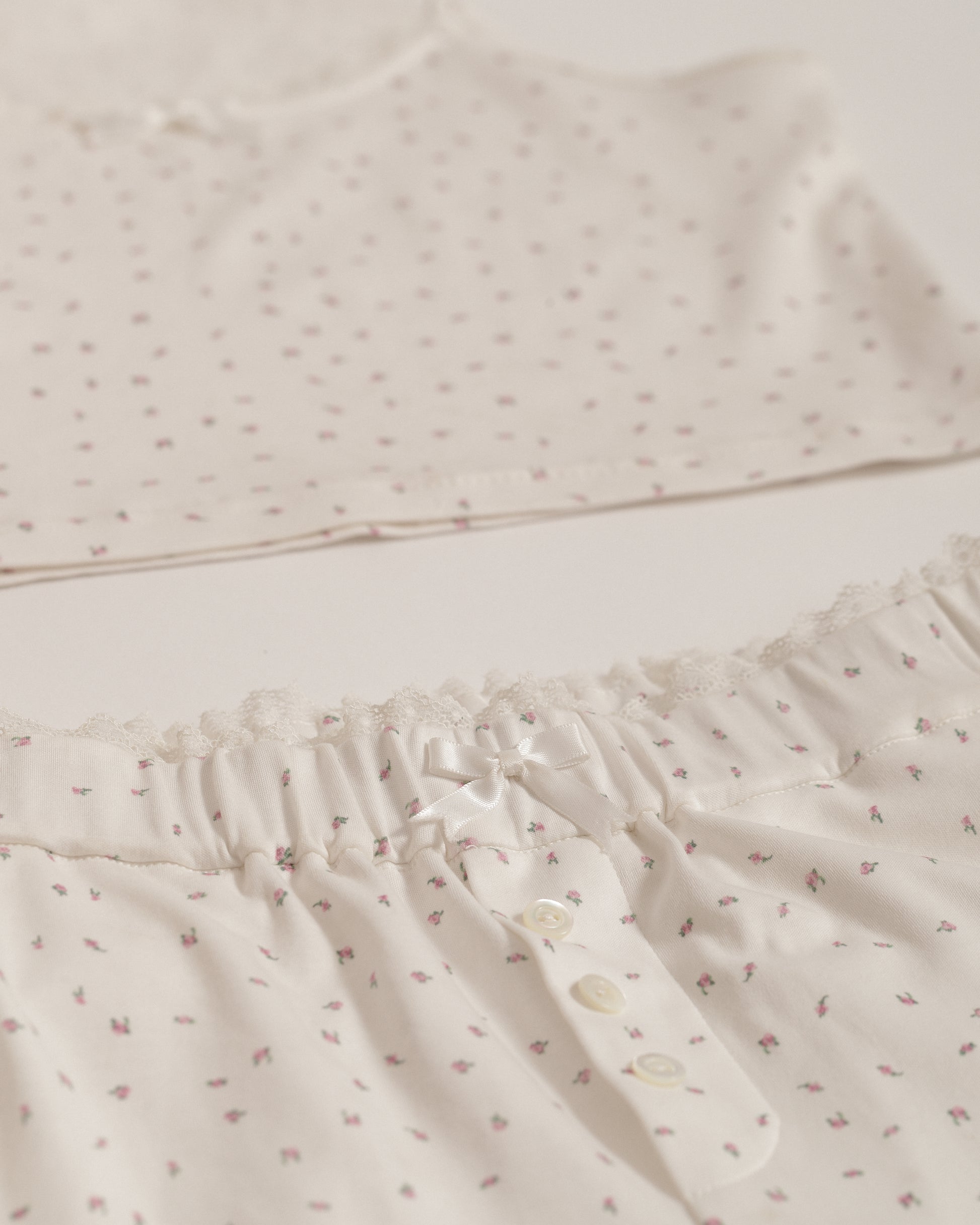 detail close up shot of dainty floral print pajamas with lace trim and bow detail