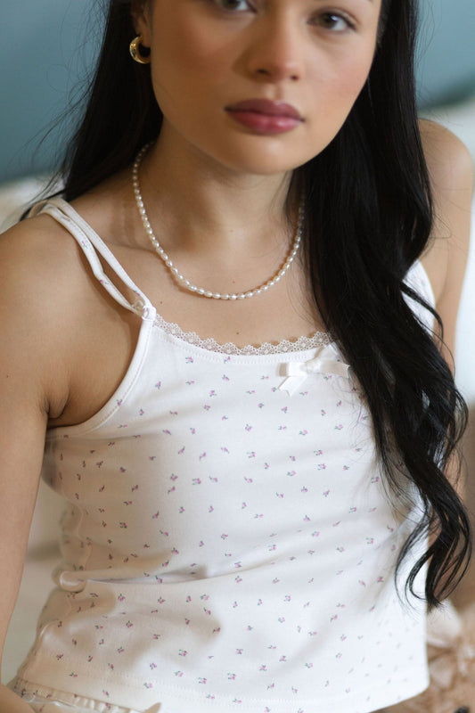 Close view of The Love Letter cotton pajama top in Garden floral, showing the lace trim and small bow at the neckline
